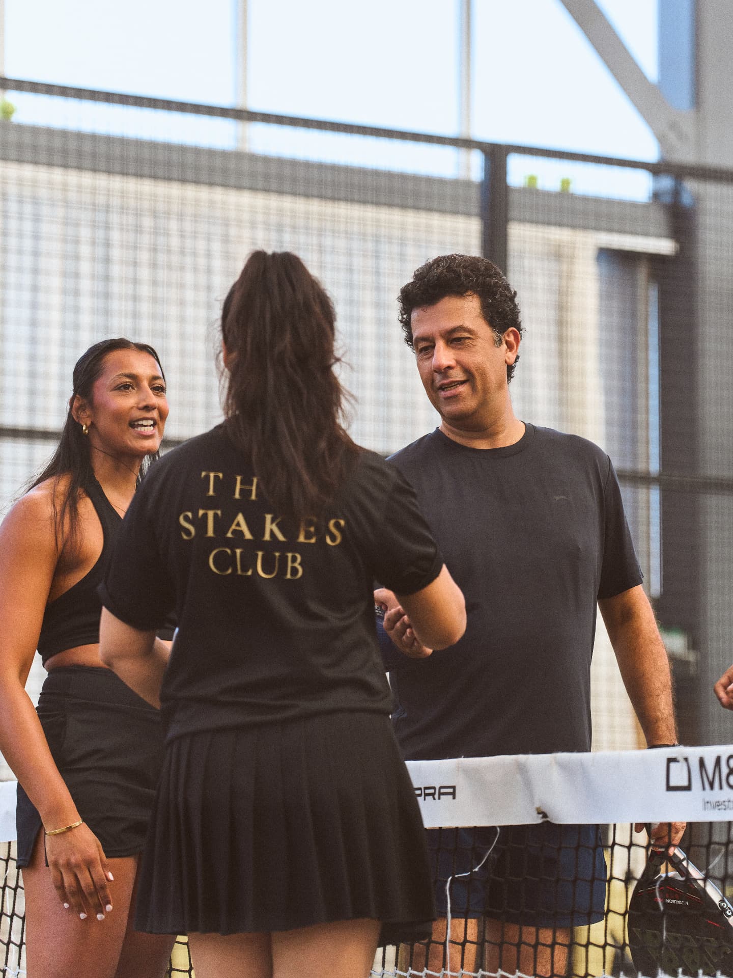 Members talking at the net at a Stakes Club event